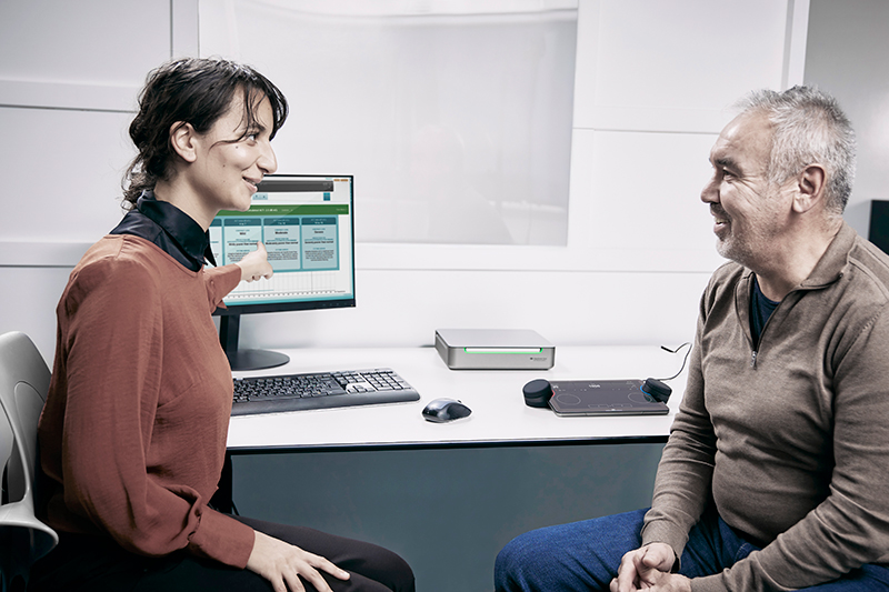 Having used the Equinox Evo and Touch Keyboard to perform the ACT test, a clinician is counseling a client on their results.