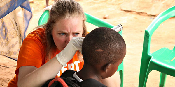 Signe Sparre Hansen performing otoscopy in young boy's left ear