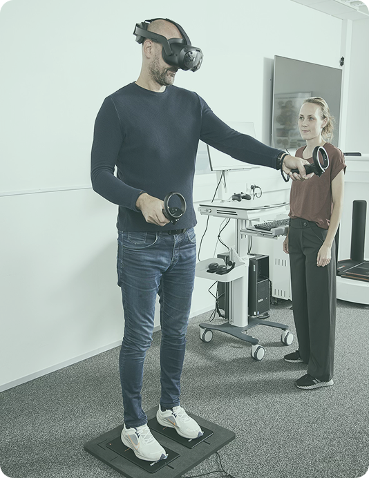 Person in blue shirt wearing VIVE VR goggles