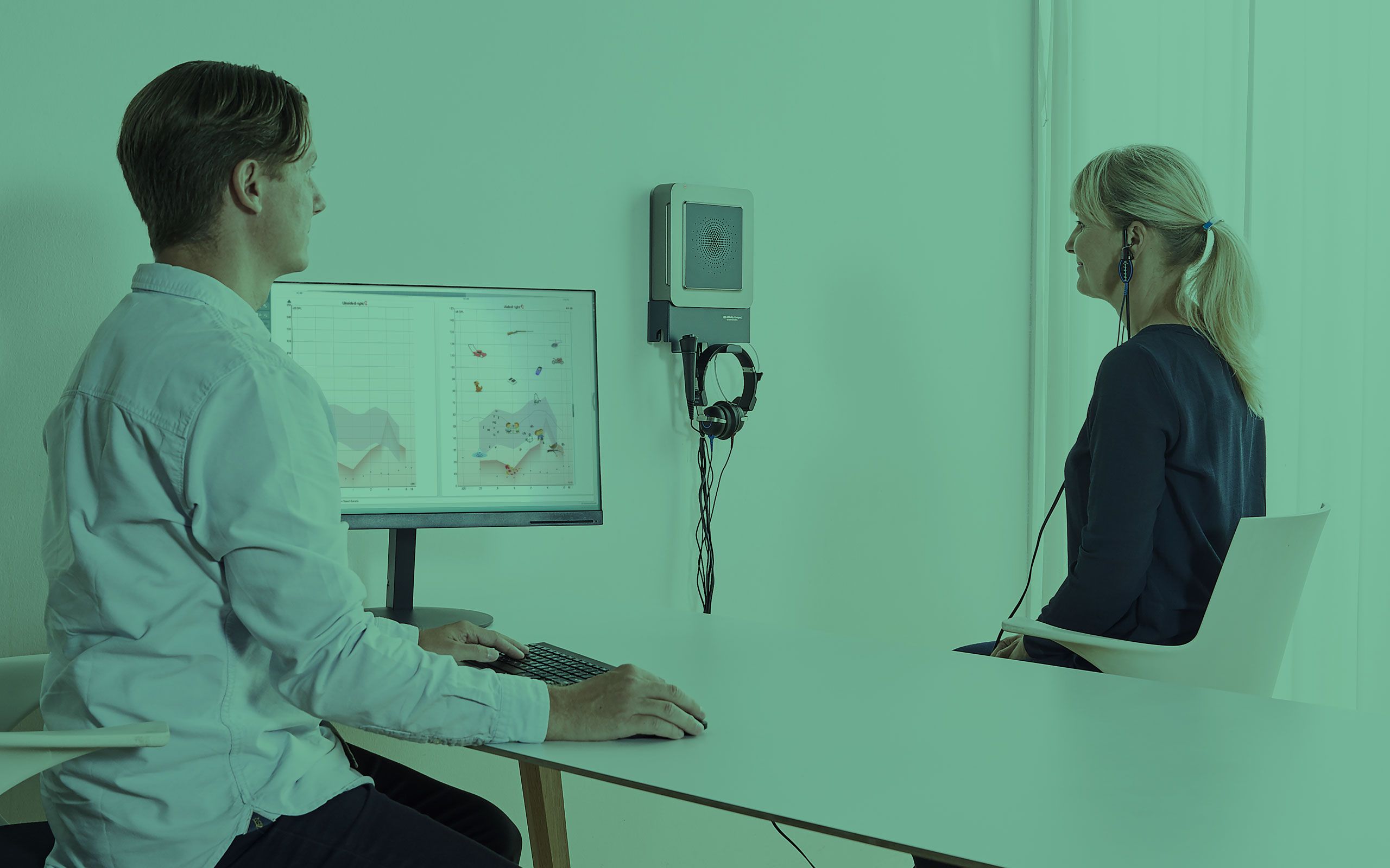 Male clinician and female patient performing visible speech mapping.