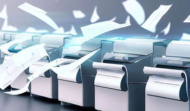 A row of scanners stood beside each other with paper flying all over the place. The scanners are omitting a blue-ish light.