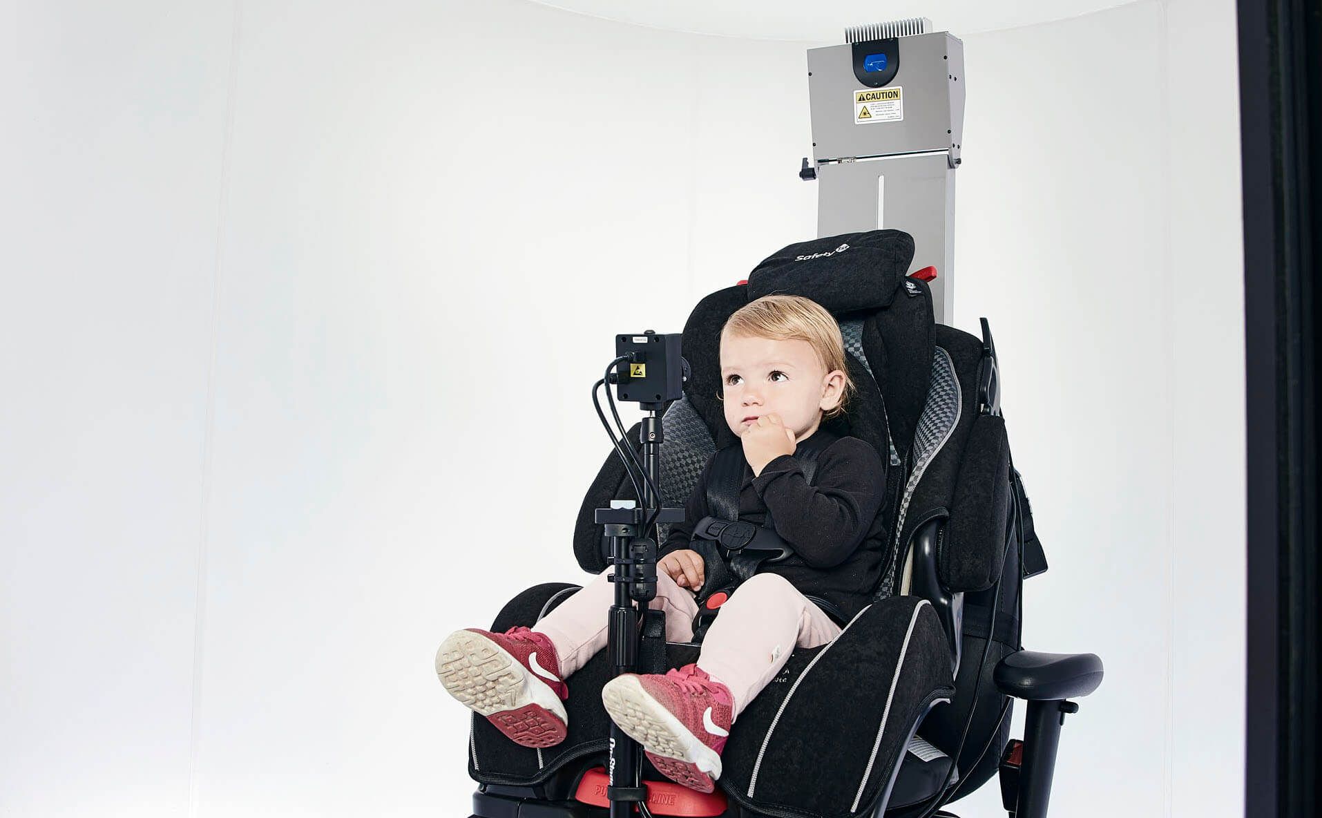 Young girl sat in car seat add-on to Orion rotary chair