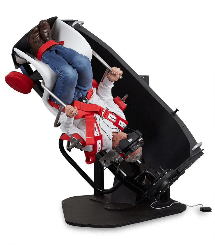 Man strapped into a TRV chair with his head facing downward