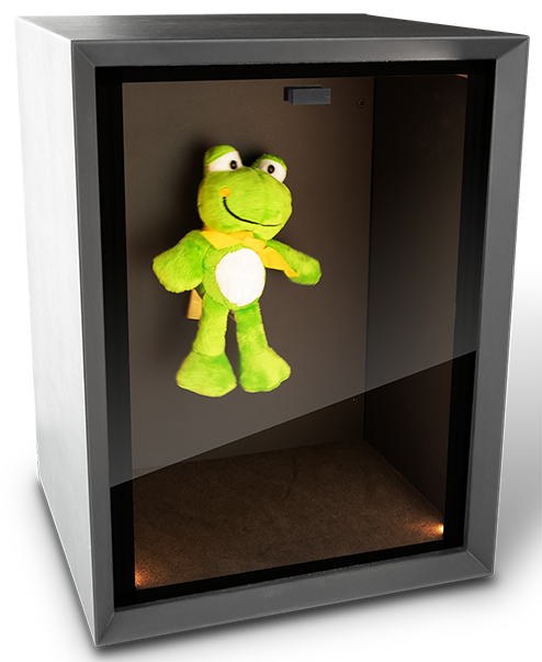 Green toy frog behind smoked Perspex in a black box and illuminated with lights located inside the box.