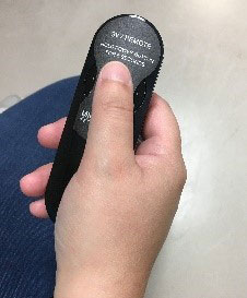 Person holding SVV remote control.
