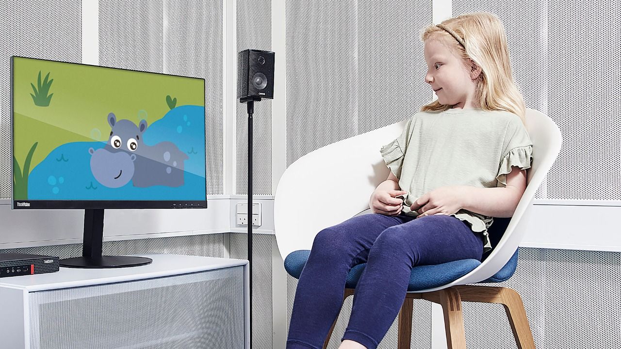 Girl looking at animation of hippo on computer screen