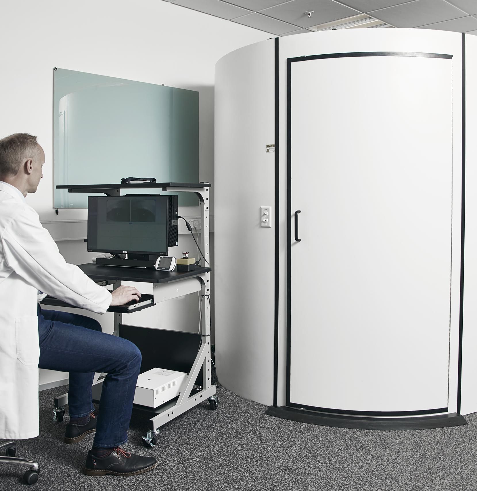 Male clinician observing rotary chair results screen
