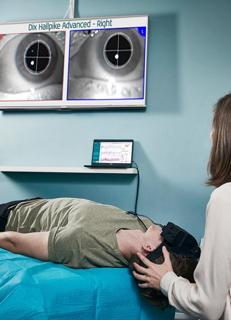 Female clinician performing Dix Hallpike Advanced on the left side with torsional analysis