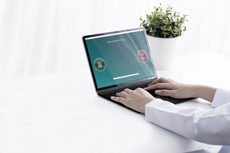 Clinician performing IA-AMTAS test on laptop