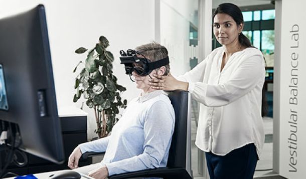 Female clinician performing oculomotor testing on female patient