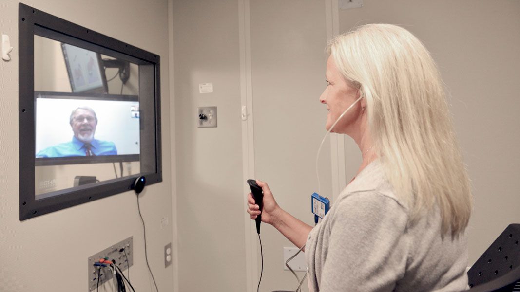Female patient looking at computer screen.