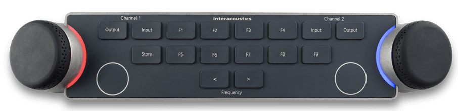 Audiometer Keyboard seen from above. There are two dials located on the left and right sides of the keyboard. The dials are encircled by LED lights which indicate different functions when in use. There are several keys between the multi-functional dials, which include and are not limited to input and output for channels one and two, store, two keys to decrease or increase the intensity, and nine F-keys labeled F1 to F9.