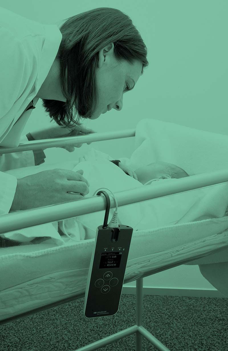 This is a photo of an infant that is undergoing an OAE test with the OtoRead from Interacoustics