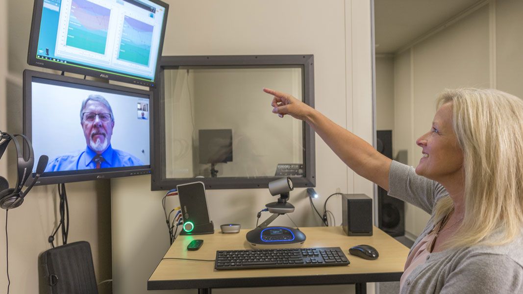 Female patient pointing at computer screen.