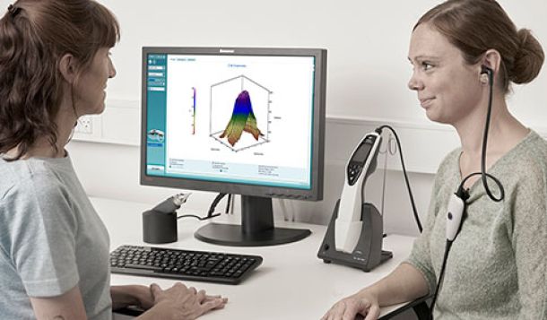 Female clinician performing wideband tympanometry in female patient