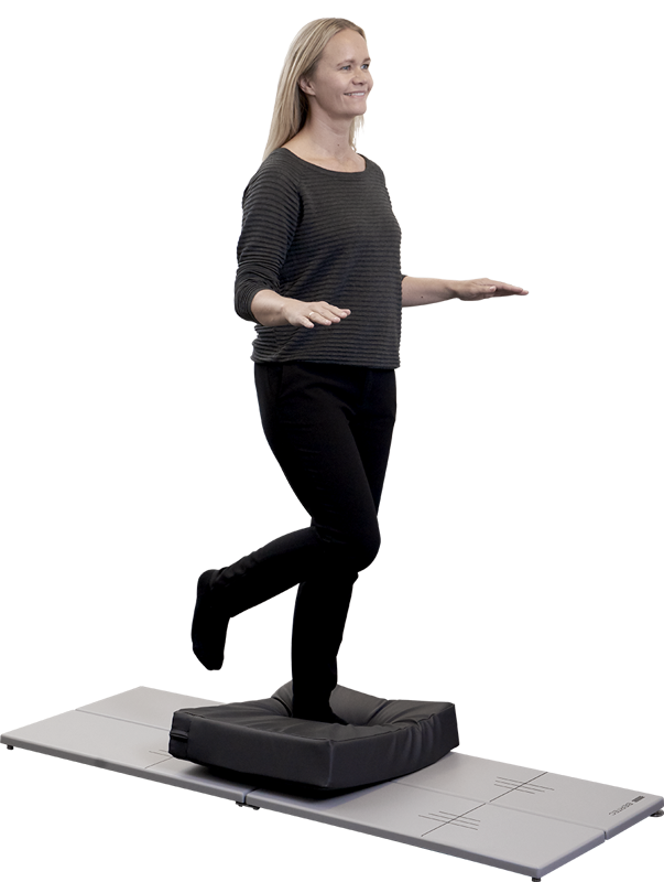 Woman standing on a foam surface placed on top of a long force plate.