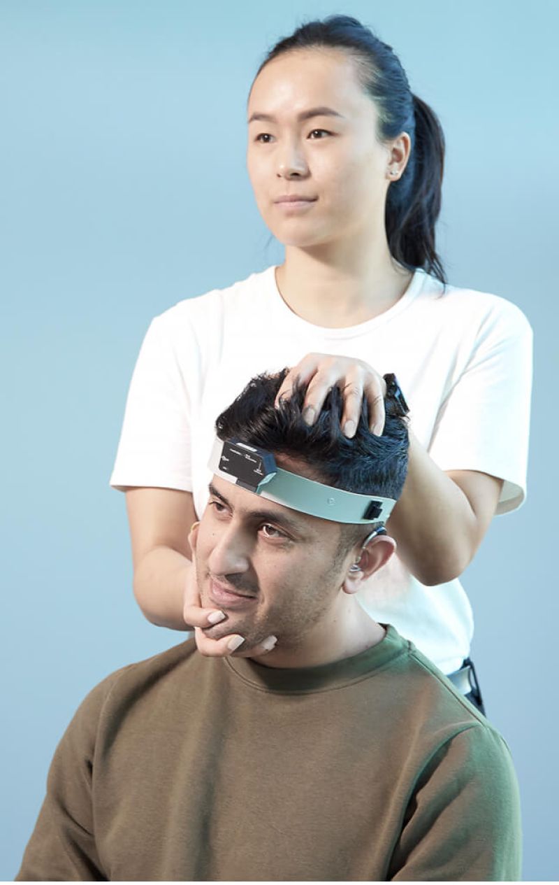 Clinician performing RALP fvHIT in patient wearing a headband with a mounted inertial measurement unit sensor