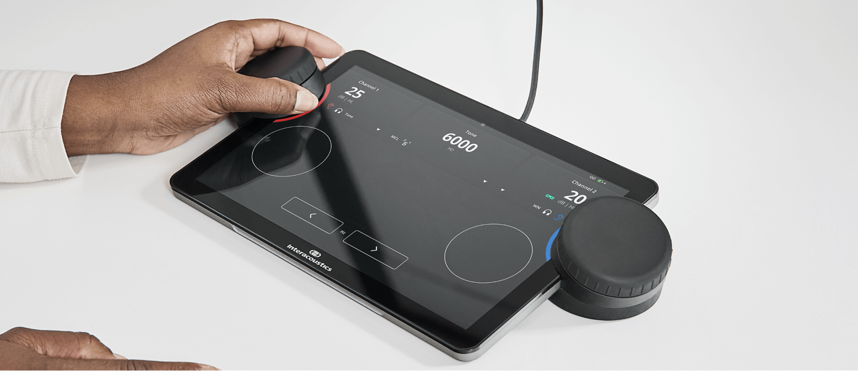 Close up of the Touch Keyboard displaying the pure tone audiometry screen. A clinician is using the left dial for the right ear