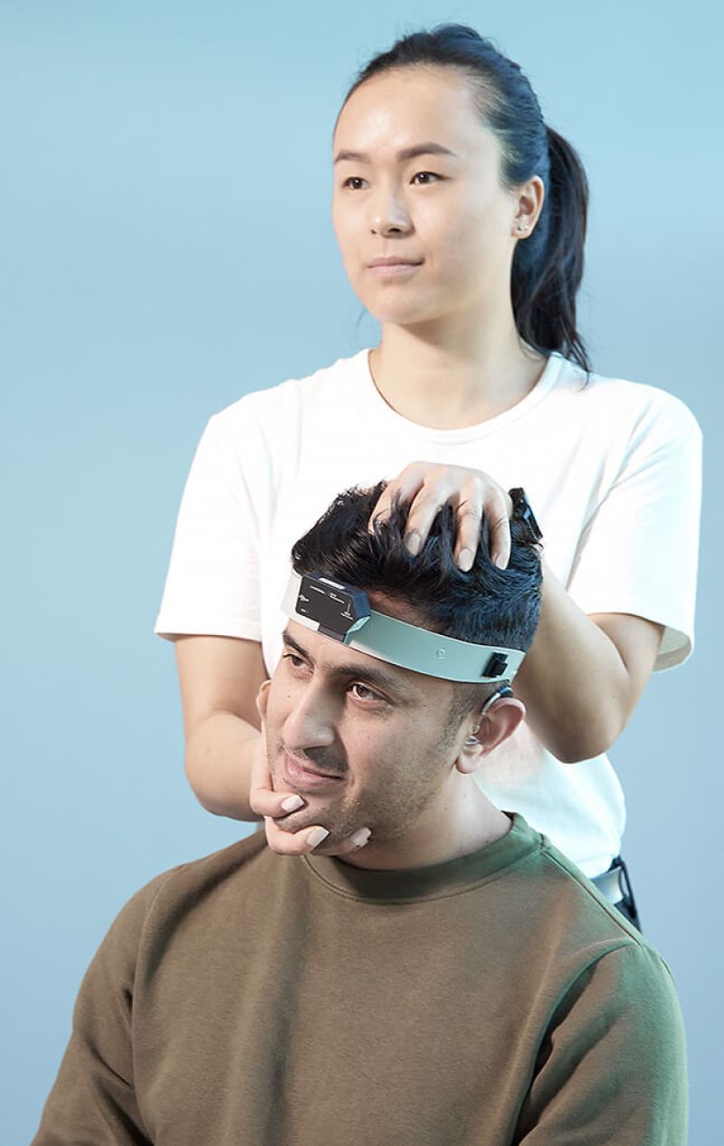 Clinician performing RALP fvHIT in patient wearing a headband with a mounted inertial measurement unit sensor