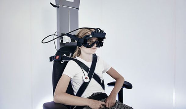 Girl in vestibular rotary chair wearing VNG goggles