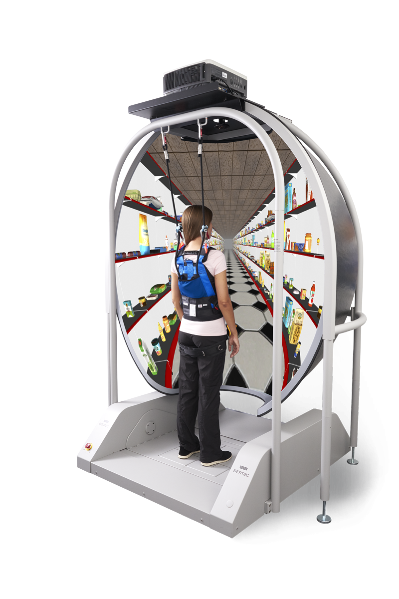 Young woman in harness facing toward a three-dimensional grocery store simulation.