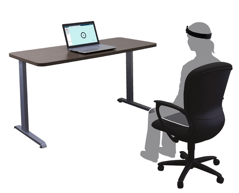Person in a chair looking towards a laptop.