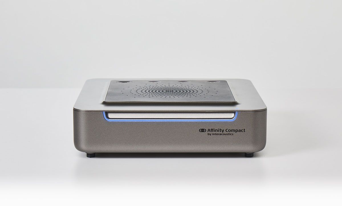 Version three of Affinity Compact. Speaker and plugs on its base. Blue light on the front of the unit.