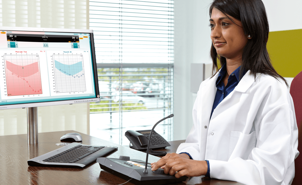Female clinician at desk performing audiometry