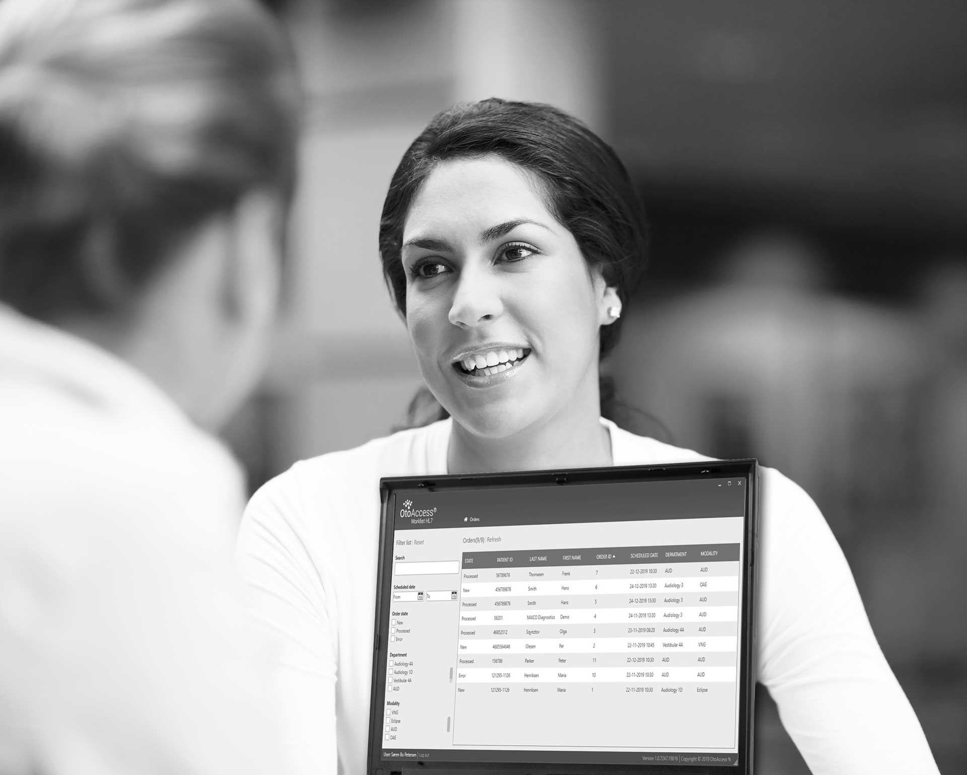 Woman smiling and an open laptop.