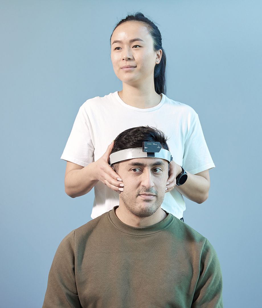 Clinician holding a patient's head, ready to perform fvHIT testing