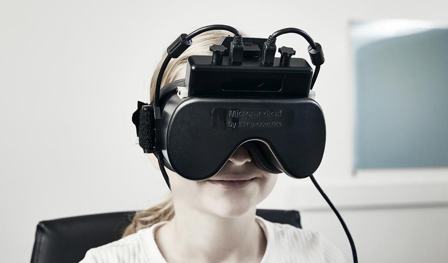 Young girl wearing VNG goggles with top mounted cameras and start button