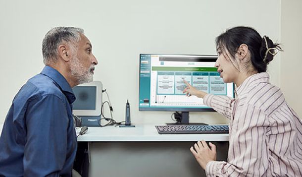 Clinician explaining Audible Contrast Threshold (ACT) test results to client