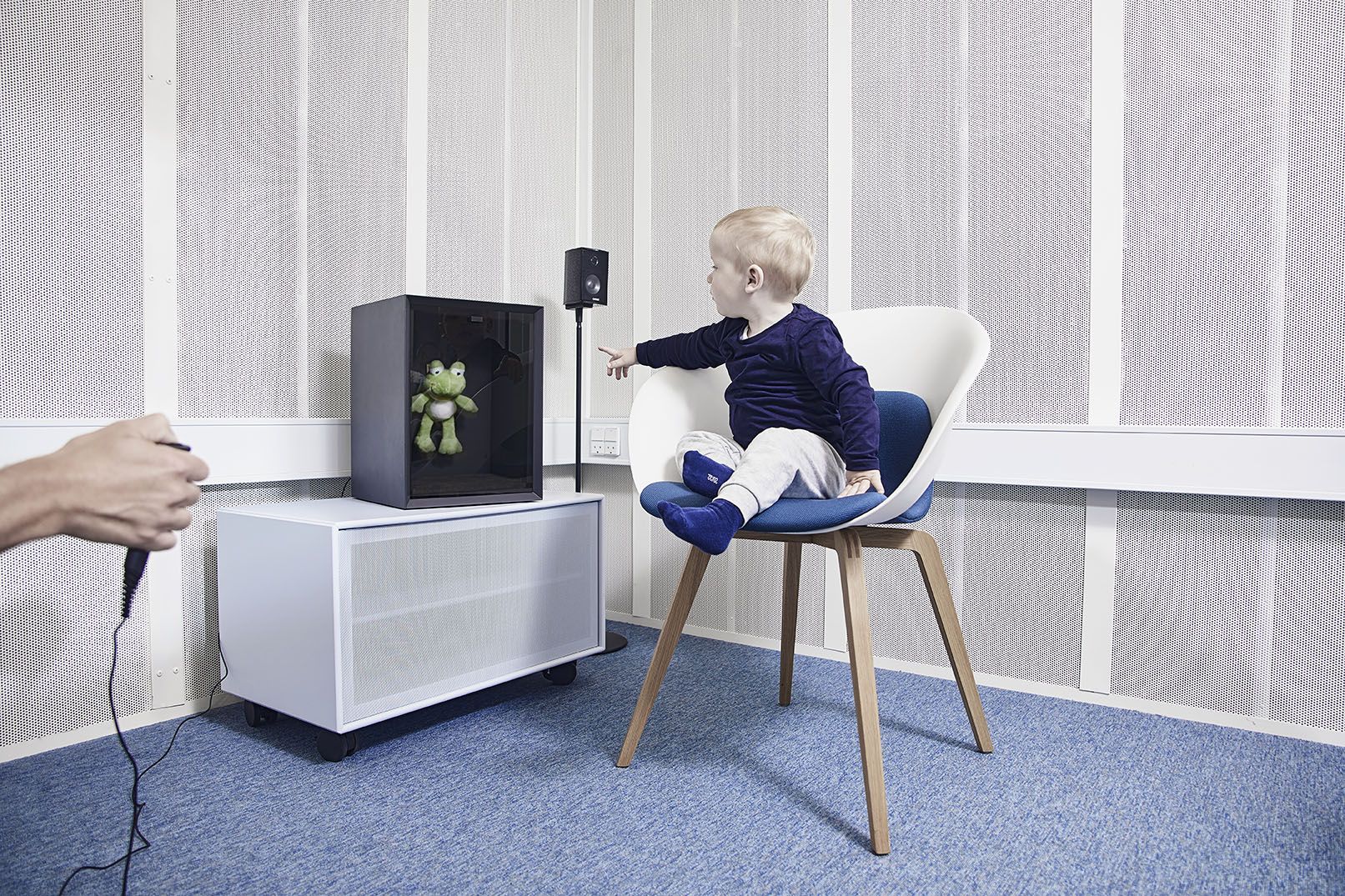 toddler pointing at animated toy frog located inside VRA201