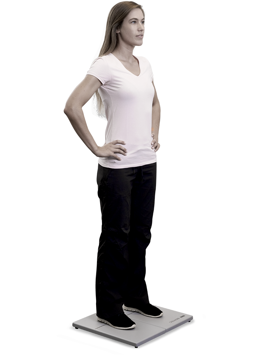 Young woman standing on small and firm force plate.